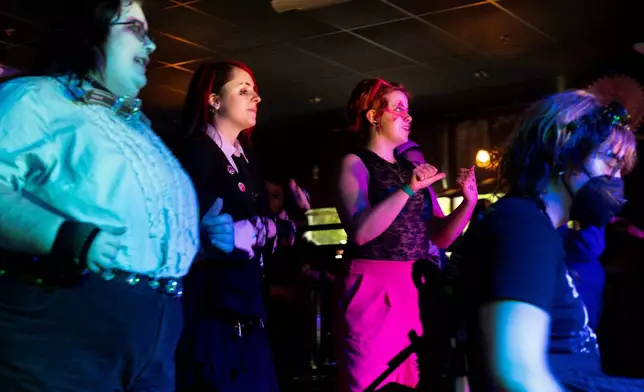 Clockwise from left, Brutus Johnson, June Arney, Caspian Brooks and Elliott Auel dance during a "Pink Pony Prom" on Friday, May 30, 2025, in Portland, Ore. (AP Photo/Jenny Kane)