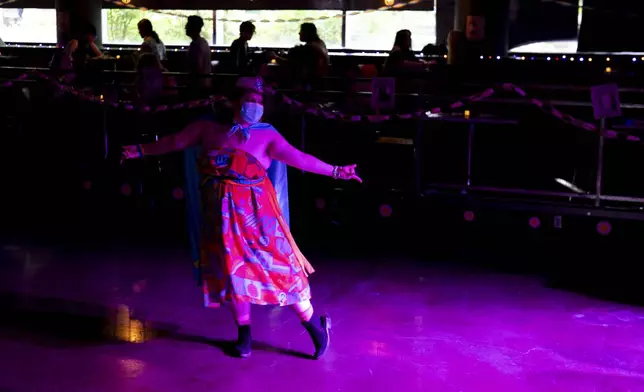Ambrose dances during a "Pink Pony Prom" held to celebrate teen and young adult members of the LGBTQ+ community on Friday, May 30, 2025, in Portland, Ore. (AP Photo/Jenny Kane)