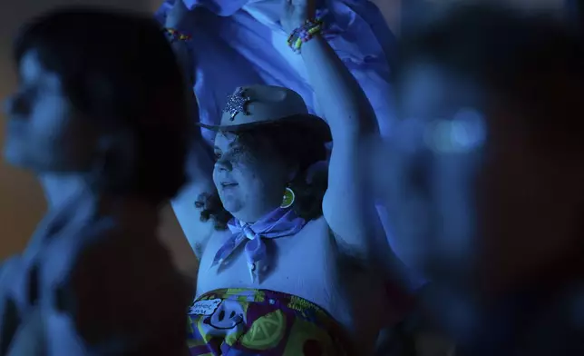 Ambrose dances during a "Pink Pony Prom" on Friday, May 30, 2025, in Portland, Ore. (AP Photo/Jenny Kane)