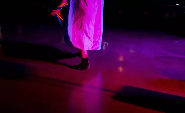 Ambrose wears a transgender pride flag while dancing during a "Pink Pony Prom" on Friday, May 30, 2025, in Portland, Ore. (AP Photo/Jenny Kane)