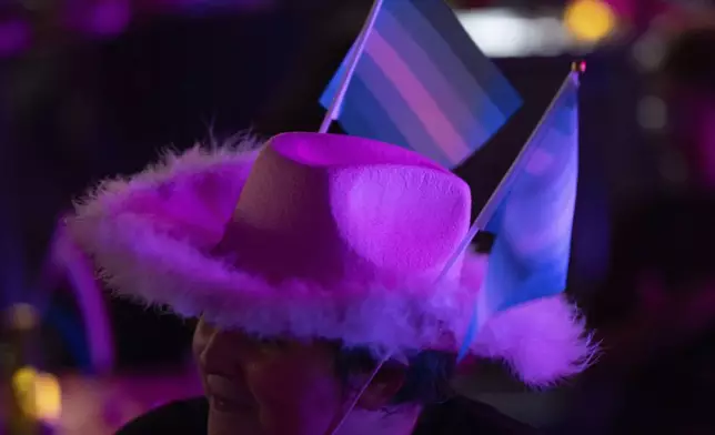 An attendee wears gay pride flags in their hat during a "Pink Pony Prom" held to celebrate teen and young adult members of the LGBTQ+ community on Friday, May 30, 2025, in Portland, Ore. (AP Photo/Jenny Kane)