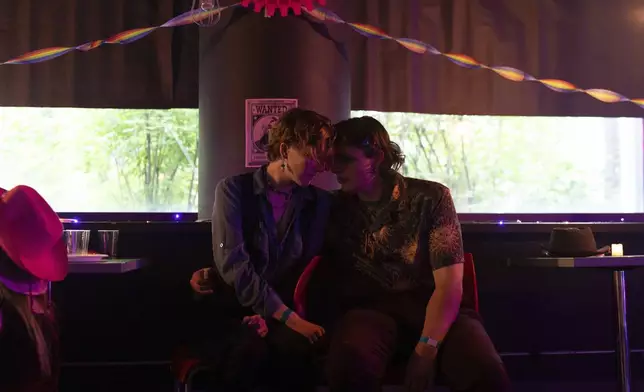 Couple Michael, right, and Perse talk during a "Pink Pony Prom" held to celebrate teen and young adult members of the LGBTQ+ community on Friday, May 30, 2025, in Portland, Ore. (AP Photo/Jenny Kane)