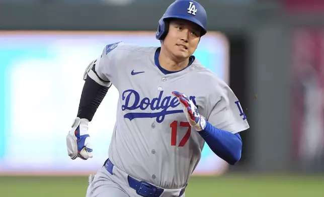 Los Angeles Dodgers' Shohei Ohtani runs to third after hitting a triple during the fifth inning of a baseball game against the Kansas City Royals, Friday, June 27, 2025, in Kansas City, Mo. (AP Photo/Charlie Riedel)