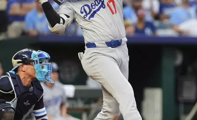 Los Angeles Dodgers' Shohei Ohtani watches his RBI triple during the fifth inning of a baseball game against the Kansas City Royals, Friday, June 27, 2025, in Kansas City, Mo. (AP Photo/Charlie Riedel)