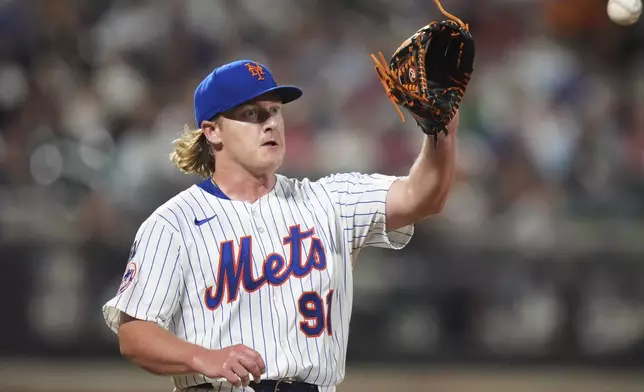 New York Mets pitcher Jonathan Pintaro covers first base for an out during the ninth inning of a baseball game against the Atlanta Braves Wednesday, June 25, 2025, in New York. (AP Photo/Frank Franklin II)