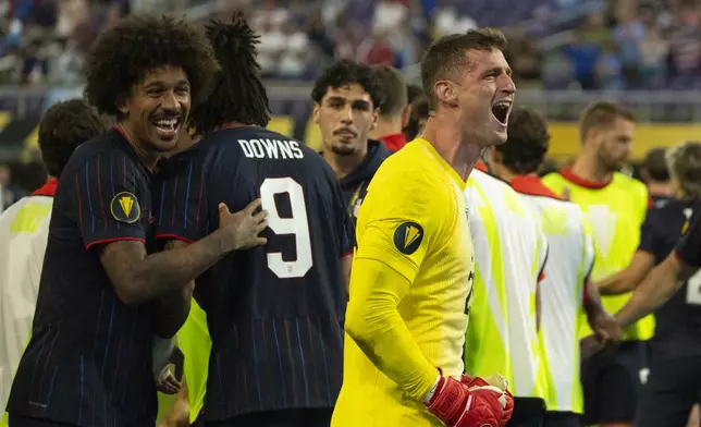 United States goalkeeper Matthew Freese, front right, reacts toward the crowd after he saved enough Costa Rica penalty kicks for his team to prevail in a CONCACAF Gold Cup quarterfinals soccer match Sunday, June 29, 2025, in Minneapolis. (Jeff Wheeler/Star Tribune via AP)