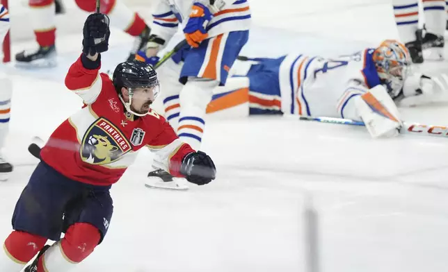 Florida Panthers' Brad Marchand (63) celebrates his goal against Edmonton Oilers goalie Stuart Skinner (74) during the first period in Game 3 of the NHL hockey Stanley Cup finals in Sunrise, Fla., Monday, June 9, 2025. (Nathan Denette/The Canadian Press via AP)