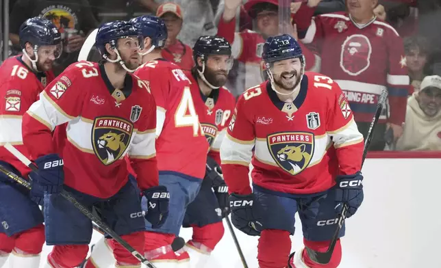 Florida Panthers center Sam Reinhart (13) skates to the bench after scoring a goal during the second period of Game 3 of the NHL Stanley Cup final against the Edmonton Oilers Monday, June 9, 2025, in Sunrise, Fla. (AP Photo/Lynne Sladky)