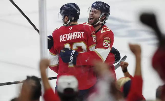 Florida Panthers' Sam Reinhart (13) celebrates his goal against the Edmonton Oilers with Carter Verhaeghe (23) during the second period in Game 3 of the NHL hockey Stanley Cup finals in Sunrise, Fla., Monday, June 9, 2025. (Nathan Denette/The Canadian Press via AP)