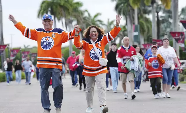 Fans arrive prior to Game 3 of the NHL hockey Stanley Cup finals between the Edmonton Oilers and the Florida Panthers in Sunrise, Fla., Monday, June 9, 2025. (Nathan Denette/The Canadian Press via AP)