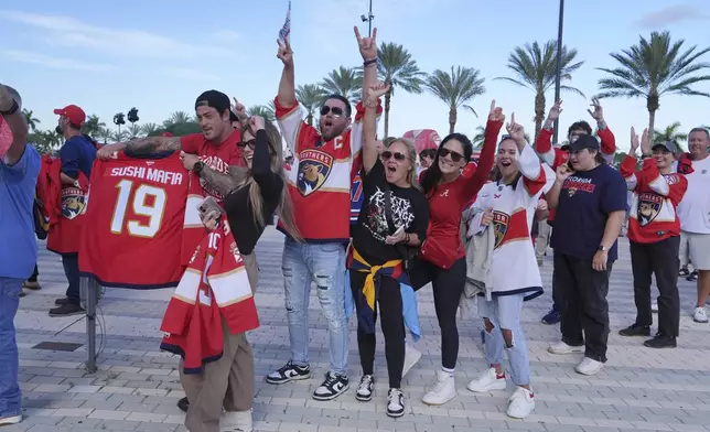 Fans cheer as they wait to enter the Amerant Bank Arena for Game 3 of the NHL Stanley Cup final between the Florida Panthers and the Edmonton Oilers, June 9, 2025, in Sunrise, Fla. (AP Photo/Lynne Sladky)