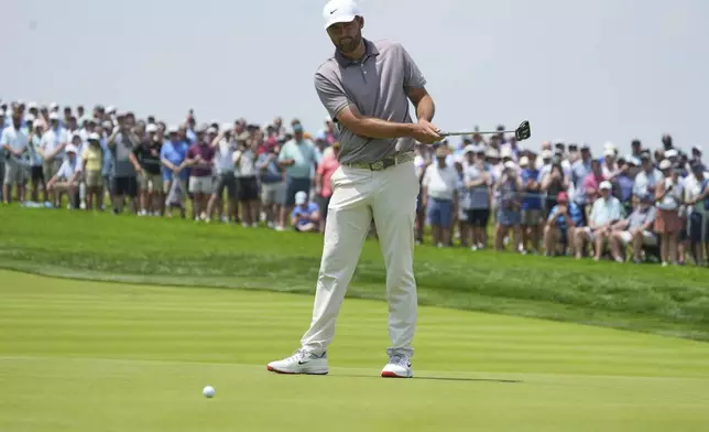 Scottie Scheffler reacts to his putt on the first hole during the first round of the U.S. Open golf tournament at Oakmont Country Club Thursday, June 12, 2025, in Oakmont, Pa. (AP Photo/Gene J. Puskar)