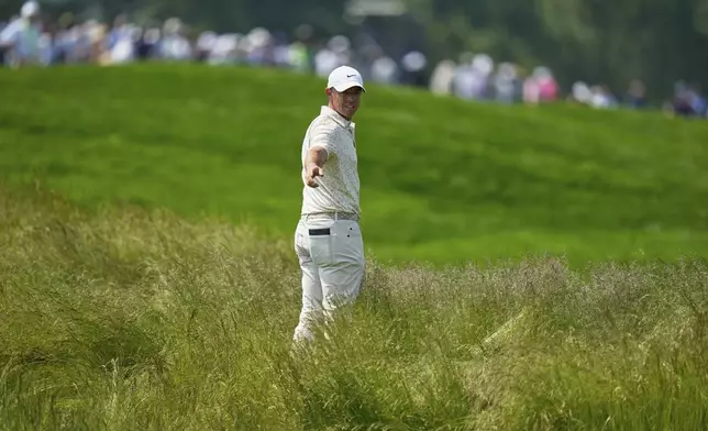 Rory McIlroy, of Northern Ireland, prepares to hit from the tall grass on the fourth hole during the first round of the U.S. Open golf tournament at Oakmont Country Club Thursday, June 12, 2025, in Oakmont, Pa. (AP Photo/Seth Wenig)