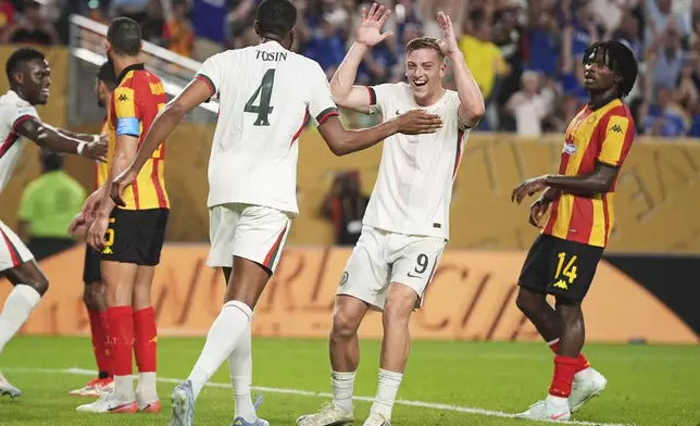 Chelsea's Tosin Adarabioyo, left, is congratulated by teammate Liam Delap after scoring his team's first goal during the Club World Cup Group D soccer match between Esperance Tunisie and Chelsea in Philadelphia, Tuesday, June 24, 2025. (AP Photo/Matt Slocum)