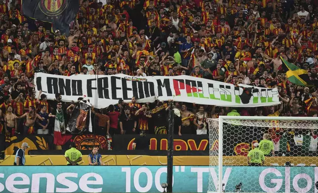 Esperance de Tunis fans hold up a pro-Palestinian banner during the Club World Cup Group D soccer match between Esperance Tunisie and Chelsea in Philadelphia, Tuesday, June 24, 2025. (AP Photo/Chris Szagola)