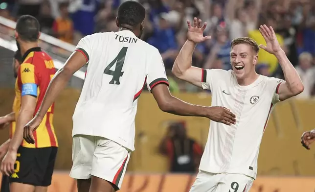 Chelsea's Tosin Adarabioyo, left, is congratulated by teammate Liam Delap after scoring his team's first goal during the Club World Cup Group D soccer match between Esperance Tunisie and Chelsea in Philadelphia, Tuesday, June 24, 2025. (AP Photo/Matt Slocum)