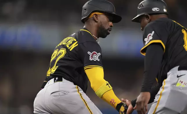 Pittsburgh Pirates' Andrew McCutchen, left, celebrates with first base coach Tarrik Brock, right, after hitting a home run during the fifth inning of a baseball game against the San Diego Padres, Saturday, May 31, 2025, in San Diego. (AP Photo/Gregory Bull)