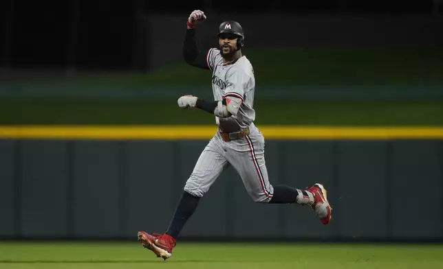 Minnesota Twins' Byron Buxton celebrates hitting a solo home run as he rounds the bases in the first inning of a baseball game against the Cincinnati Reds, Wednesday, June 18, 2025, in Cincinnati. (AP Photo/Carolyn Kaster)