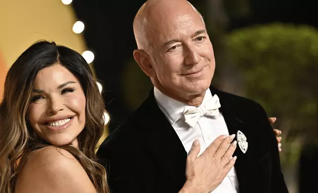 FILE - Lauren Sanchez and Jeff Bezos arrives at the Vanity Fair Oscar Party at the Wallis Annenberg Center for the Performing Arts in Beverly Hills, Calif., March 2, 2025. (Photo by Evan Agostini/Invision/AP File)