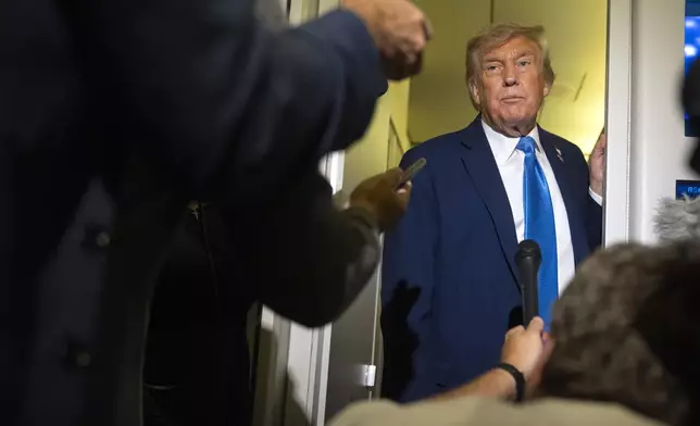 President Donald Trump speaks with reporters while flying aboard Air Force One en route from Calgary, Canada to Joint Base Andrews, Md., late Monday, June 16, 2025. (AP Photo/Mark Schiefelbein)