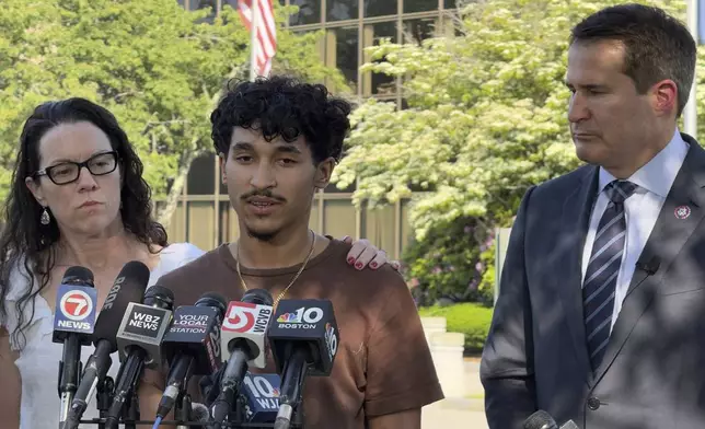 Marcelo Gomes da Silva, 18, center, a Massachusetts high school student who came to the U.S. from Brazil at age 7 and was detained by U.S. Immigration and Customs Enforcement agents Saturday, May 31, 2025, speaks to journalists after being released from detention on bond as Rep. Seth Moulton, D-Mass., right, listens, Thursday, June 5, in Burlington, Mass. (AP Photo/Rodrique Ngowi)