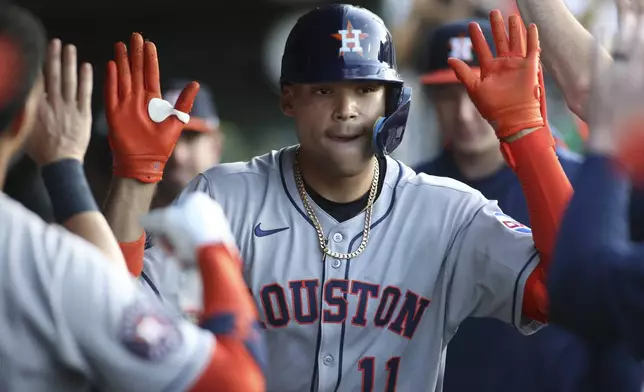 Houston Astros' Cam Smith (11) celebrates with teammates after hitting a solo home run against the Athletics during the fourth inning of a baseball game Tuesday, June 17, 2025, in West Sacramento, Calif. (AP Photo/Scott Marshall)