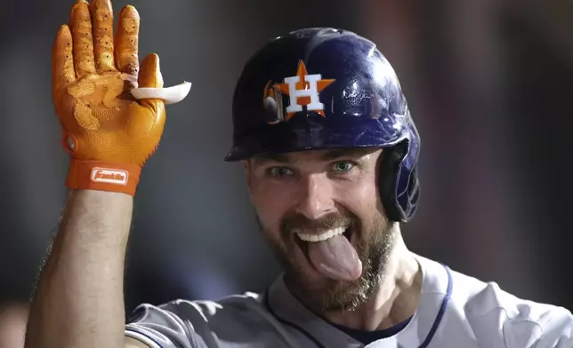 Houston Astros' Cooper Hummel celebrates hitting a two run home run in the dugout during the seventh inning of a baseball game against the Athletics Tuesday, June 17, 2025, in West Sacramento, Calif. (AP Photo/Scott Marshall)