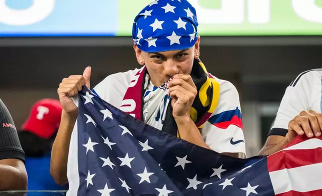 A United States fan celebrates a goal during a CONCACAF Gold Cup soccer match against Haiti Sunday, June 22, 2025, in Arlington, Texas. (AP Photo/Jessica Tobias)
