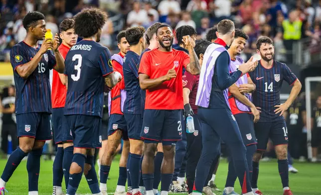 United States defender Mark McKenzie celebrates with teammates after a win over Haiti in a CONCACAF Gold Cup soccer match, Sunday, June 22, 2025, in Arlington, Texas. (AP Photo/Jessica Tobias)