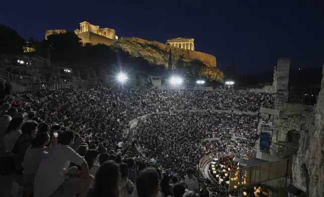 Spectators wait for Giacomo Puccini's "Turandot" premiere by the Greek National Opera athe Odeon of Herodes Atticus under the ancient Acropolis hill during the 70th Athens Epidaurus Festival in Athens, Greece, Sunday, June 1, 2025. (AP Photo/Thanassis Stavrakis)