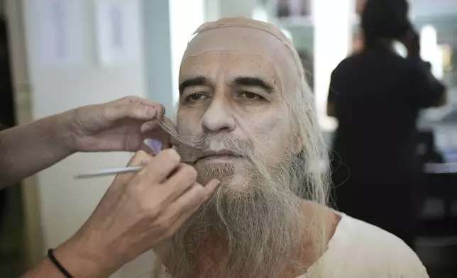 Tenor Nikos Stefanou gets his make-up ahead of Giacomo Puccini's "Turandot" performance during the 70th Athens Epidaurus Festival at the Odeon of Herodes Atticus in Athens, Greece, Tuesday, June 3, 2025. (AP Photo/Thanassis Stavrakis)