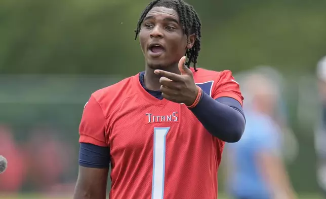 Tennessee Titans quarterback Cam Ward (1) talks to a coach during practice at NFL football minicamp, Thursday, June 12, 2025, in Nashville, Tenn. (AP Photo/George Walker IV)