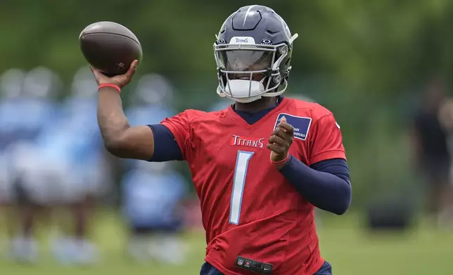 Tennessee Titans quarterback Cam Ward (1) looks to throw a pass during practice at NFL football minicamp, Thursday, June 12, 2025, in Nashville, Tenn. (AP Photo/George Walker IV)