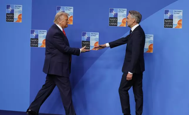 President Donald Trump is greeted by Netherland's Prime Minister Dick Schoof, right, during an official welcome at the NATO summit in The Hague, Netherlands, Wednesday, June 25, 2025. (AP Photo/Geert Vanden Wijngaert)