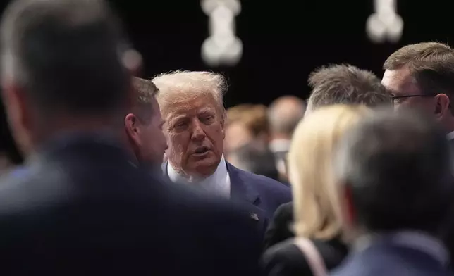 President Donald Trump shakes hands as he arrives for a plenary session at the NATO summit in The Hague, Netherlands, Wednesday, June 25, 2025. (AP Photo/Alex Brandon)