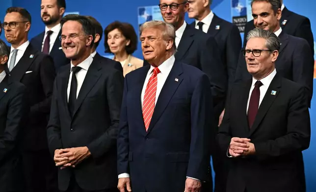 NATO Secretary General Mark Rutte, from left, President Donald Trump and Britain's Prime Minister Keir Starmer pose with NATO country leaders for a family photo during the NATO summit in The Hague, Netherlands, Wednesday, June 25, 2025. (Ben Stansall/Pool Photo via AP)