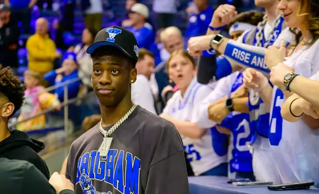 FILE - AJ Dybantsa, who has committed to BYU next year, stands with the fans during the second half of an NCAA basketball game between BYU and West Virginia Saturday, March 1, 2025, in Provo, Utah. (AP Photo/Tyler Tate, File)