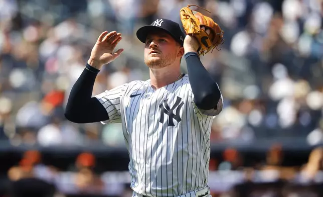 New York Yankees pitcher Clarke Schmidt reacts as he heads to the dugout in the seventh inning of a baseball game against the Baltimore Orioles, Saturday, June 21, 2025, in New York. (AP Photo/Noah K. Murray)