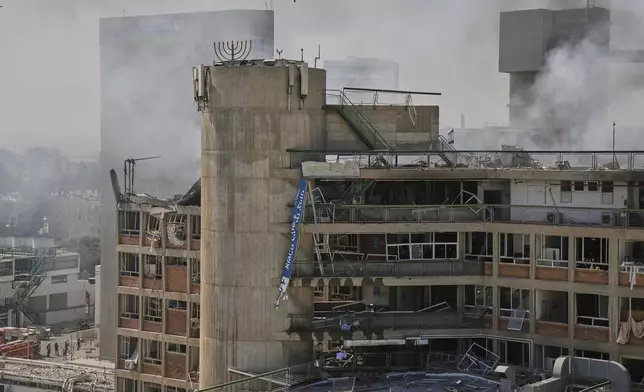 Smokes raises from a building of the Soroka hospital complex after it was hit by a missile fired from Iran in Beersheba, Israel, Thursday, June 19, 2025. (AP Photo/Leo Correa)