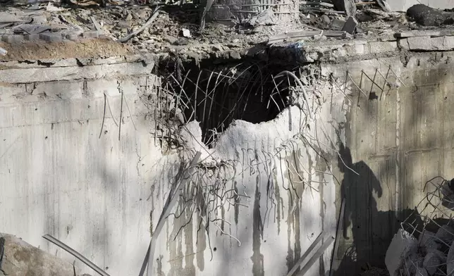 A direct hit from an Iranian missile strike is seen in a building in Ramat Gan, Israel, Thursday, June 19, 2025. (AP Photo/Oded Balilty)