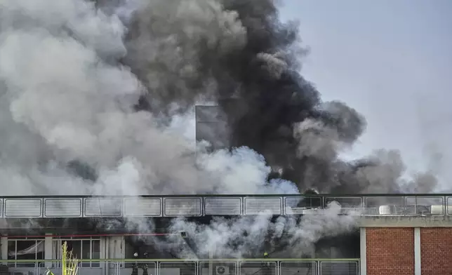 Firefighters work in a building of the Soroka hospital complex after it was hit by a missile fired from Iran in Beersheba, Israel, Thursday, June 19, 2025. (AP Photo/Leo Correa)