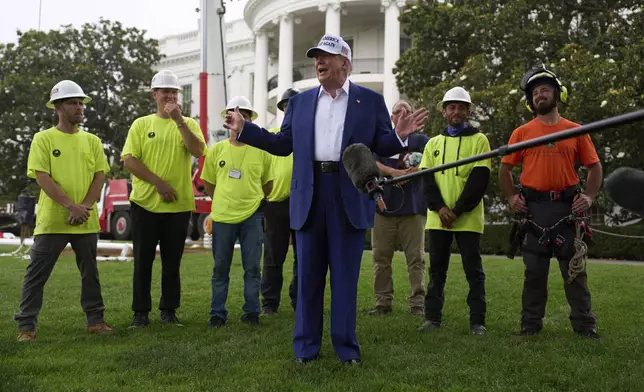 President Donald Trump speaks with reporters before a flag pole is installed on the South Lawn of the White House, Wednesday, June 18, 2025, in Washington. (AP Photo/Evan Vucci)