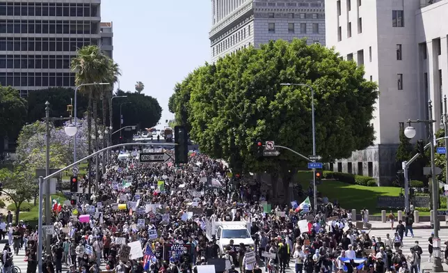 EDS NOTE: OBSCENITY - Protesters march from City Hall to the Metropolitan Detention Center in downtown Los Angeles, Sunday, June 8, 2025, following last night's immigration raid protest. (AP Photo/Jae Hong)