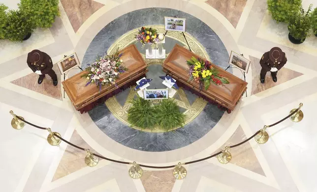 Minnesota State Representative Melissa Hortman, Mark Hortman and their dog, Gilbert, lie in state at the Minnesota State Capital in St. Paul, Minn., on Friday, June 27, 2025. (Alex Kormann/Star Tribune via AP)
