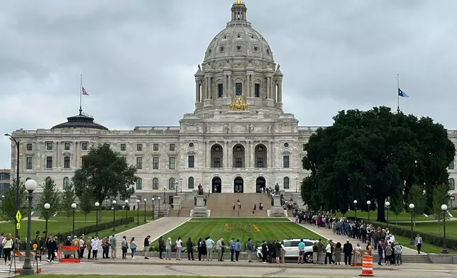 People wait on line to pay their respects to former Minnesota House Speaker Melissa Hortman, who will lie in state with her husband, Mark, and their golden retriever, Gilbert at the Minnesota Capitol rotunda on Friday, June 17, 2025 in St. Paul, Minn. (AP Photo/Mark Vancleave)