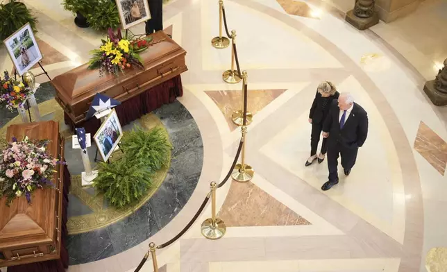 Gov. Tim Walz and his wife Gwen Walz walk into the rotunda to pay their respect to former Minnesota House Speaker Melissa Hortman, who will lie in state with her husband, Mark, and their golden retriever, Gilbert at the Minnesota Capitol rotunda on Friday, June 17, 2025 in St. Paul, Minn. (Alex Kormann/Star Tribune via AP)