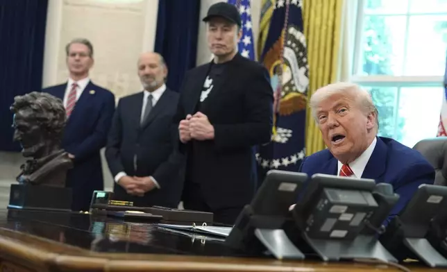 President Donald Trump, from right, speaks during a news conference with Elon Musk as Commerce Secretary Howard Lutnick and Treasury Secretary Scott Bessent listen in the Oval Office of the White House, Friday, May 30, 2025, in Washington. (AP Photo/Evan Vucci)