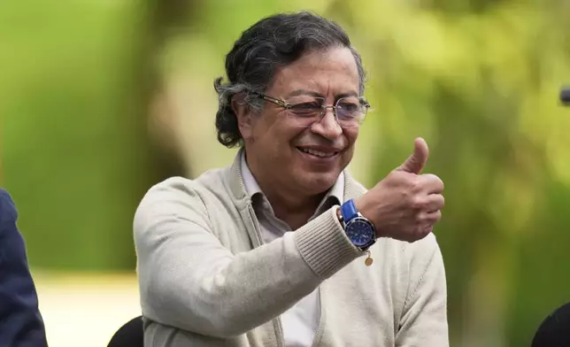 Colombia's President Gustavo Petro gives a thumbs up before signing a labor reform bill into law, in Bogota, Colombia, Wednesday, June 25, 2025. (AP Photo/Fernando Vergara)