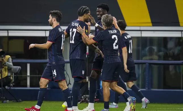United States forward Patrick Agyemang (24), center right, is congratulated by teammates after scoring a goal during a CONCACAF Gold Cup soccer match against Haiti, Sunday, June 22, 2025, in Arlington, Texas. (AP Photo/Jessica Tobias)