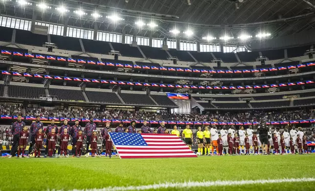 United States , left, and Haiti players line up for opening ceremonies before a CONCACAF Gold Cup soccer match Sunday, June 22, 2025, in Arlington, Texas. (AP Photo/Jessica Tobias)